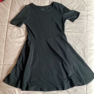 Primary size 8-9 dress. Short-sleeve, black w/ side seam pockets.